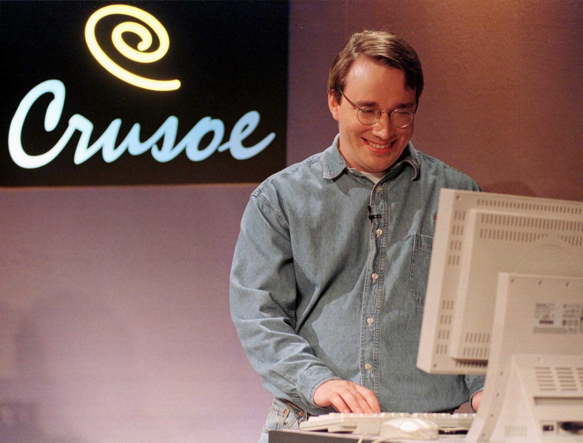 Transmeta Corp. developer Linus Torvalds, the creator of the Linux Operating System, smiles as he pl..