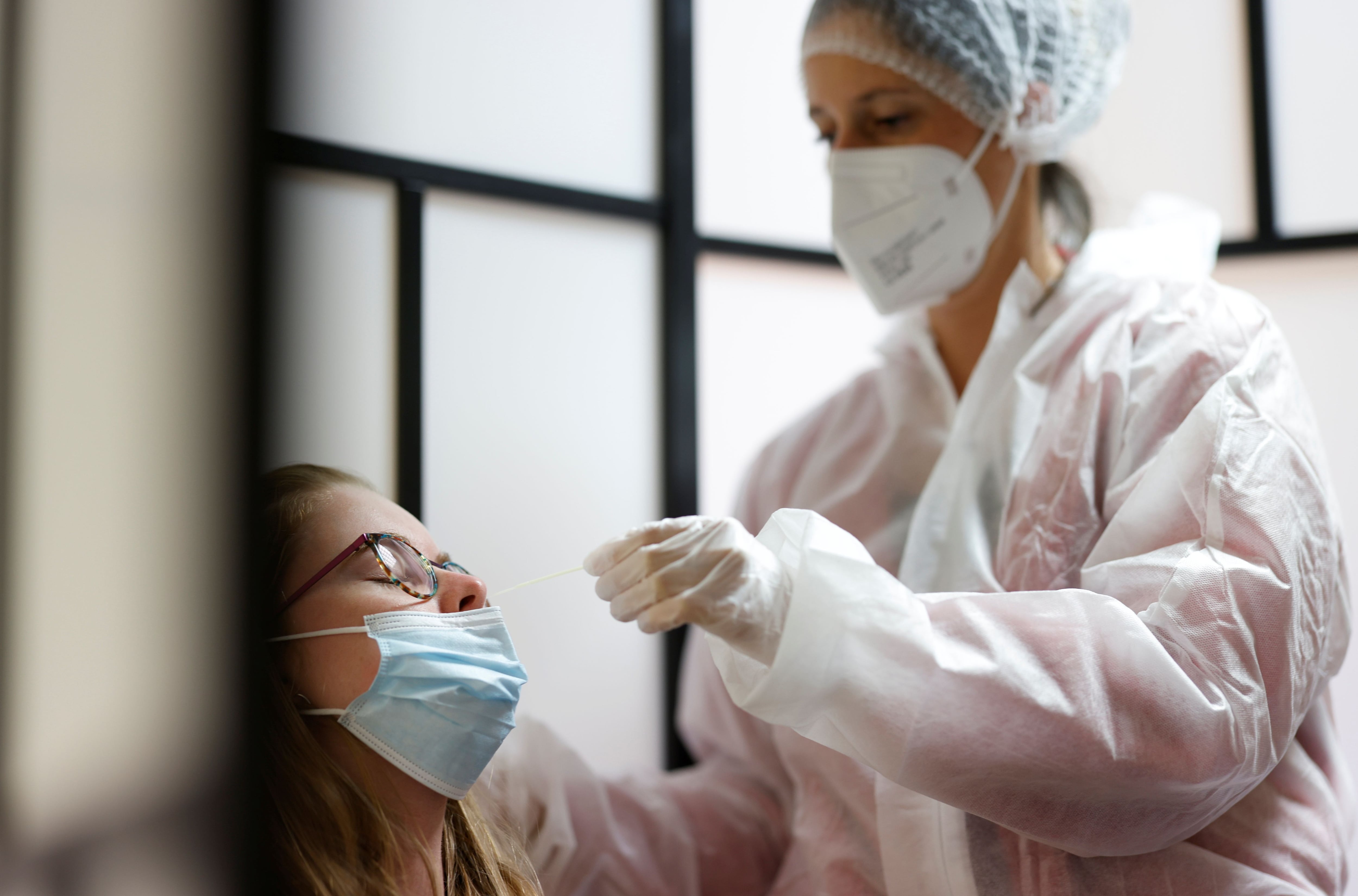 A medical worker administers a nasal swab to a patient at a coronavirus disease (COVID-19) testing centre in Les Sorinieres