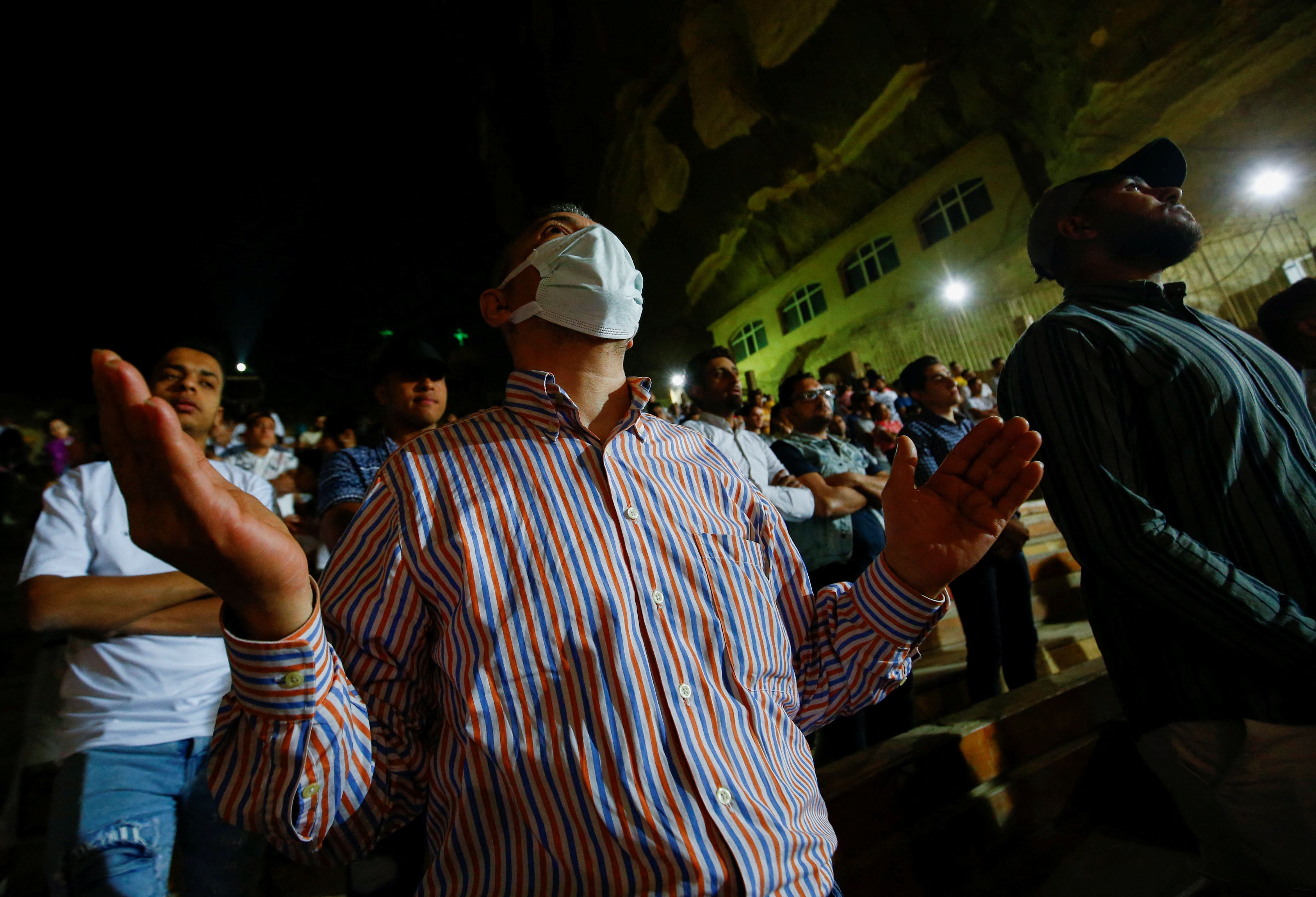 Egyptian Coptic Orthodox Christians attend Easter mass in the Samaan el-Kharaz Monastery in the Mokattam Mountain area of Cairo