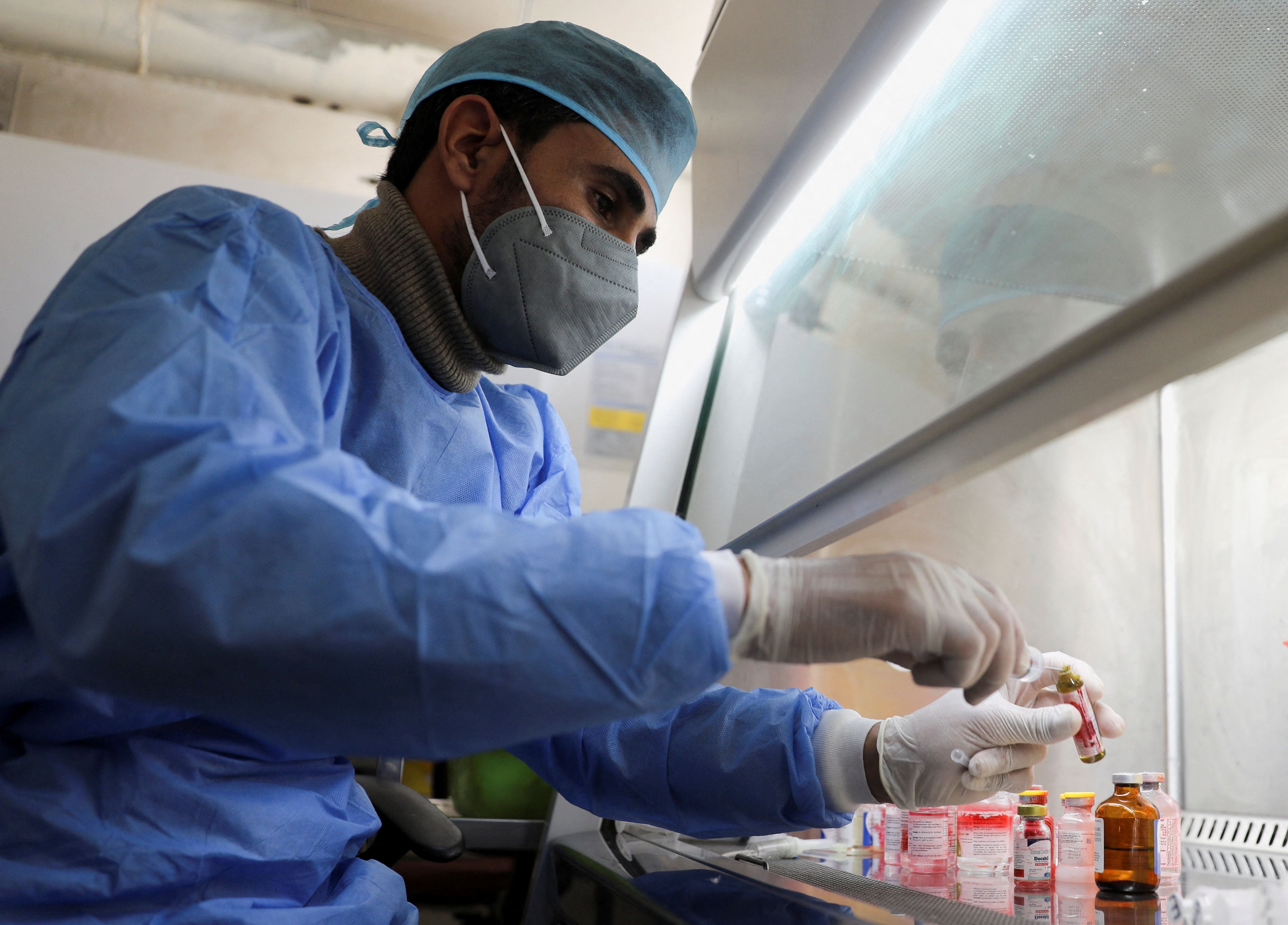 An employee of the National Oncology Center prepares medicines at the center in Sanaa