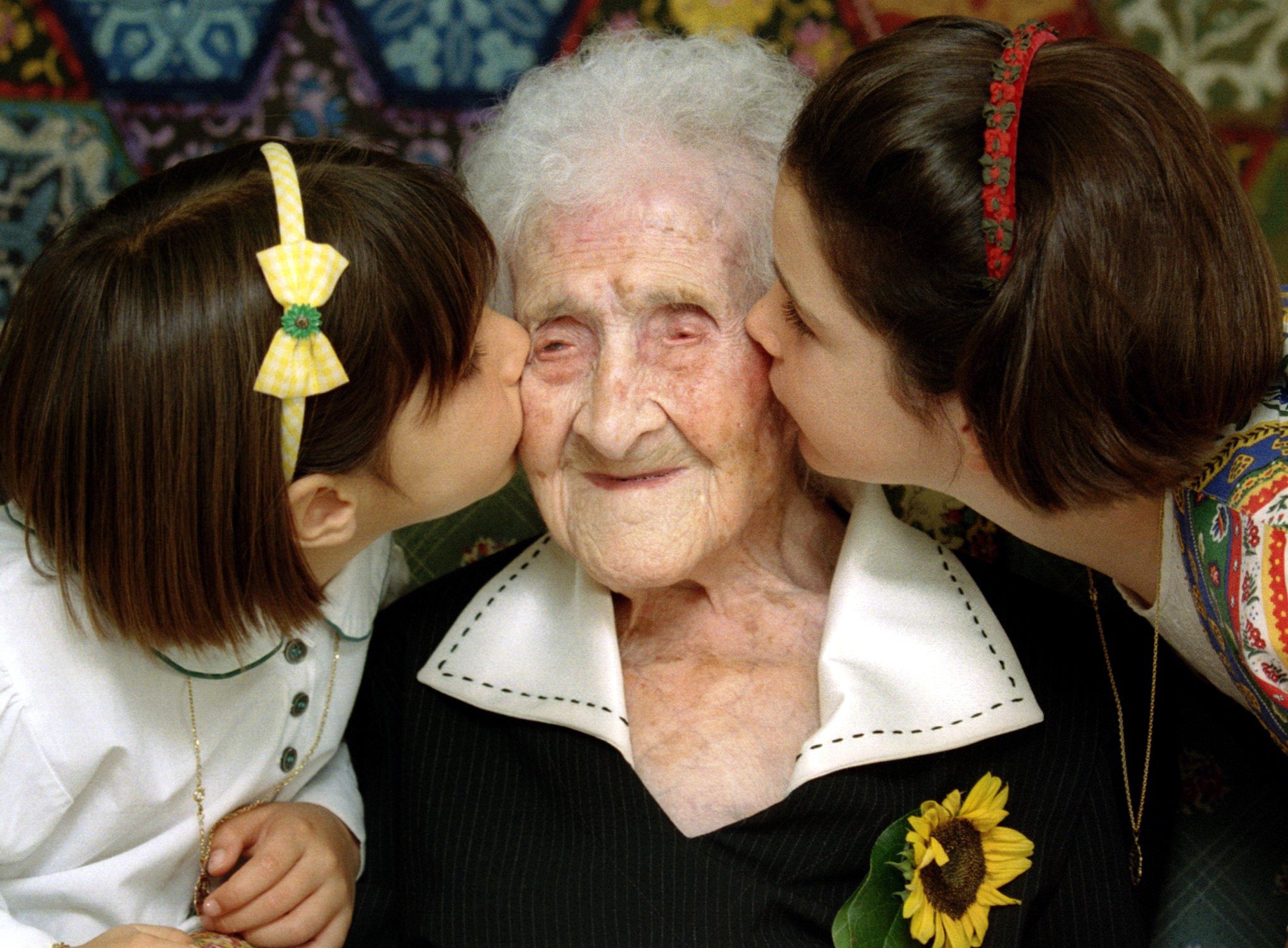 The World's oldest woman, Jeanne Calment, 120 years old, is kissed by two young girls during a special ceremony in a retirement home in Arles