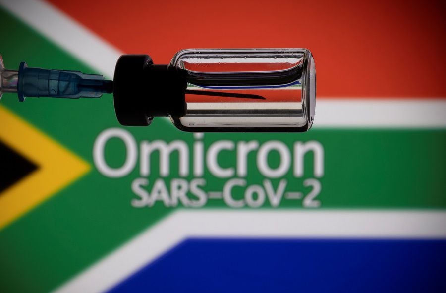 FILE PHOTO: A vial and a syringe are seen in front of a displayed South Africa flag and words "Omicron SARS-CoV-2" in this illustration taken