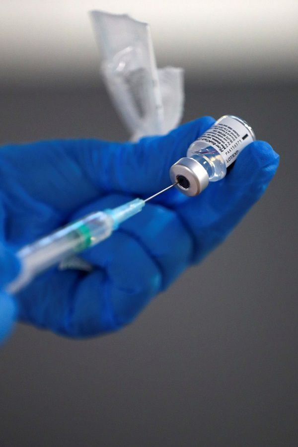 A nurse fills a syringe with a second dose of the Pfizer-BioNTech COVID-19 vaccine in Madrid