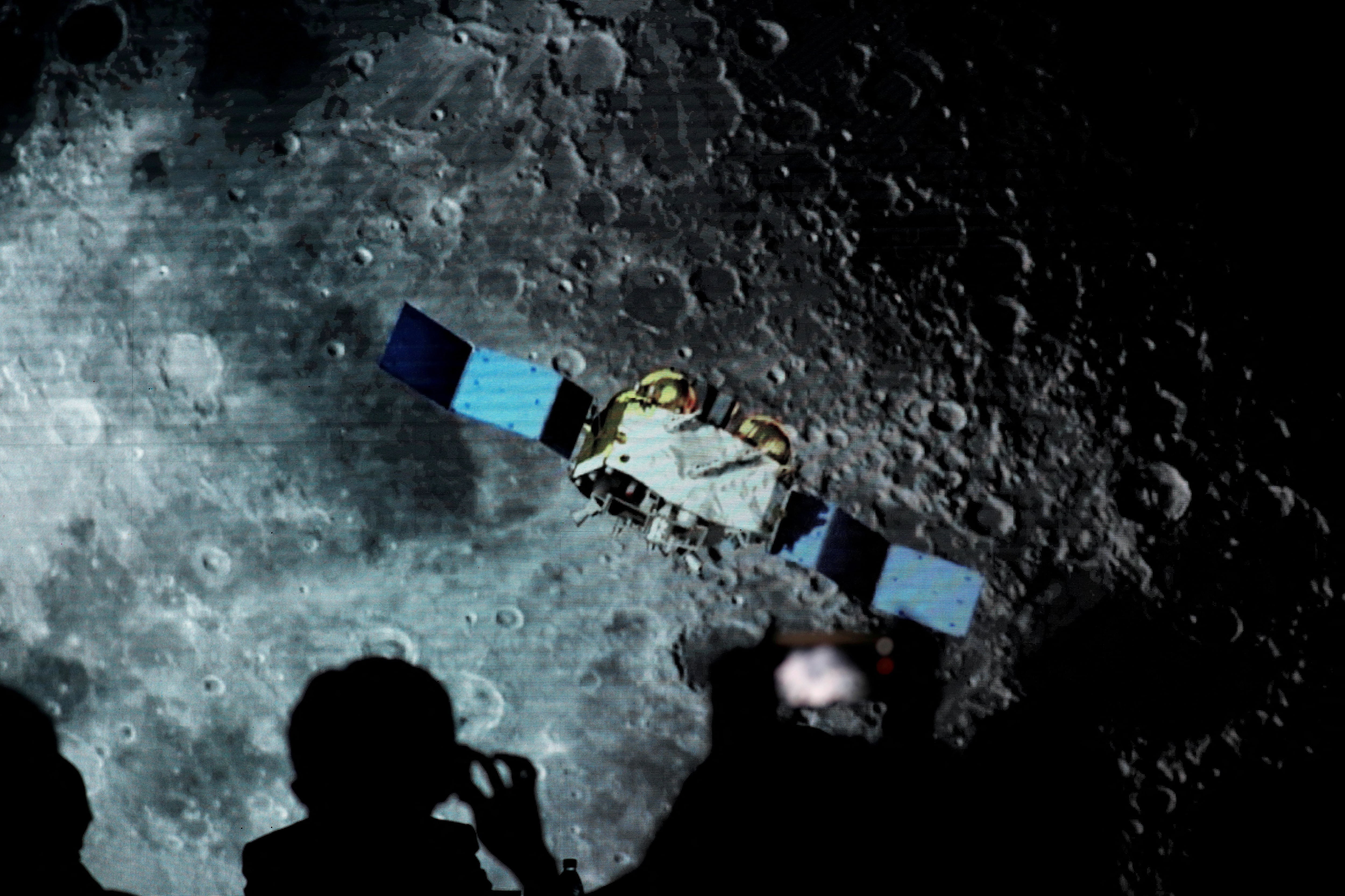 FILE PHOTO: Screen shows footages of spacecraft for Chang'e-5 Mission, during an event on China’s lunar exploration program, at the National Astronomical Observatories of Chinese Academy of Sciences, in Beijing