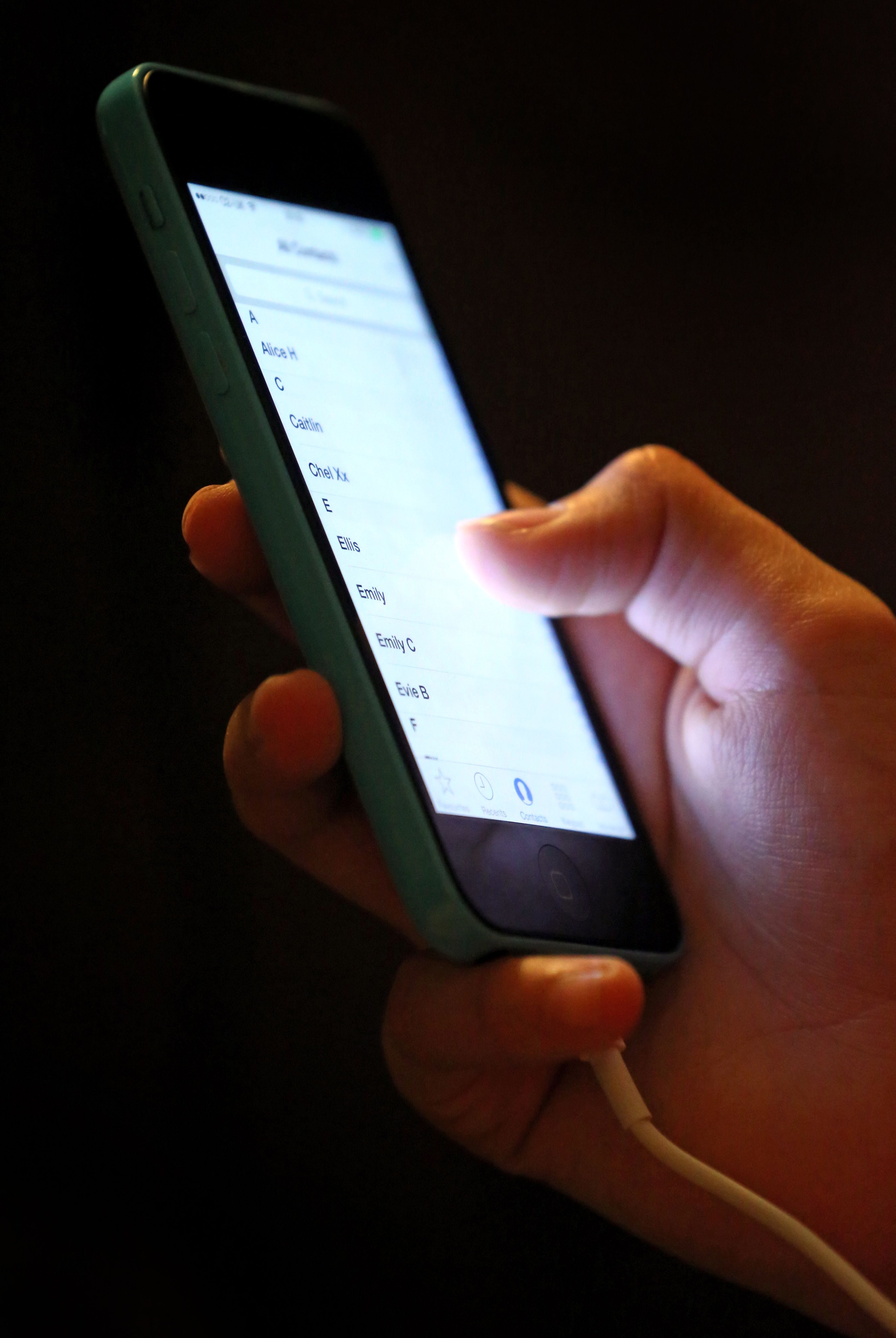 Teenager using mobile phone stock