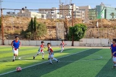 Un entrenamiento de la escuela de fútbol de Palestina, con Ramallah de fondo.