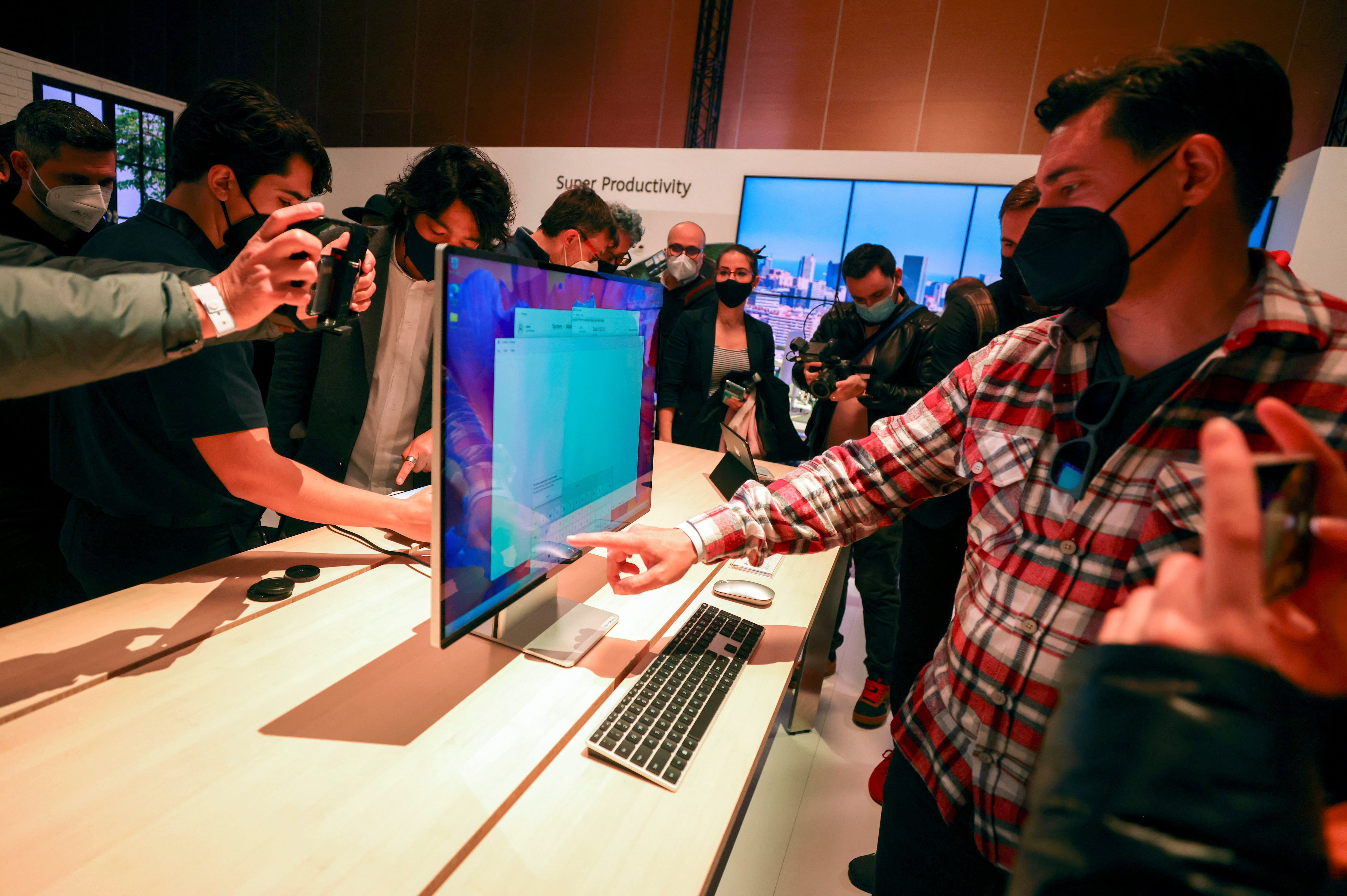 People look at the Huawei MateStation X during Huawei products launch event in Barcelona