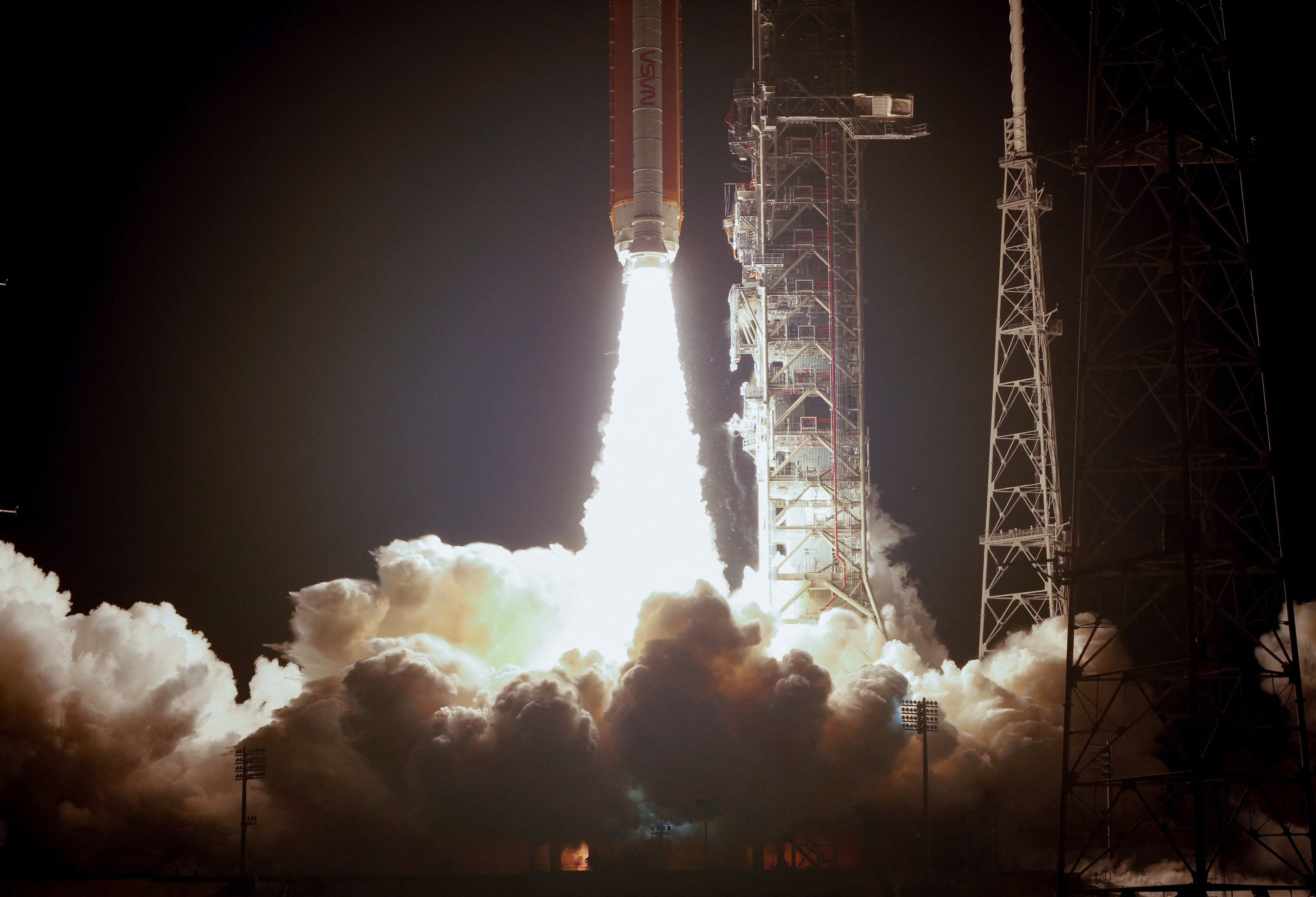 NASA's next-generation moon rocket, the Space Launch System (SLS) rocket with the Orion crew capsule, lifts off from launch complex 39-B