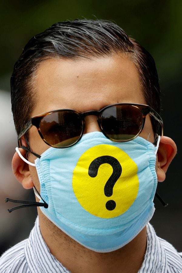 Man wears a protective face mask decorated with a question mark during outbreak of the coronavirus disease (COVID-19) in New York