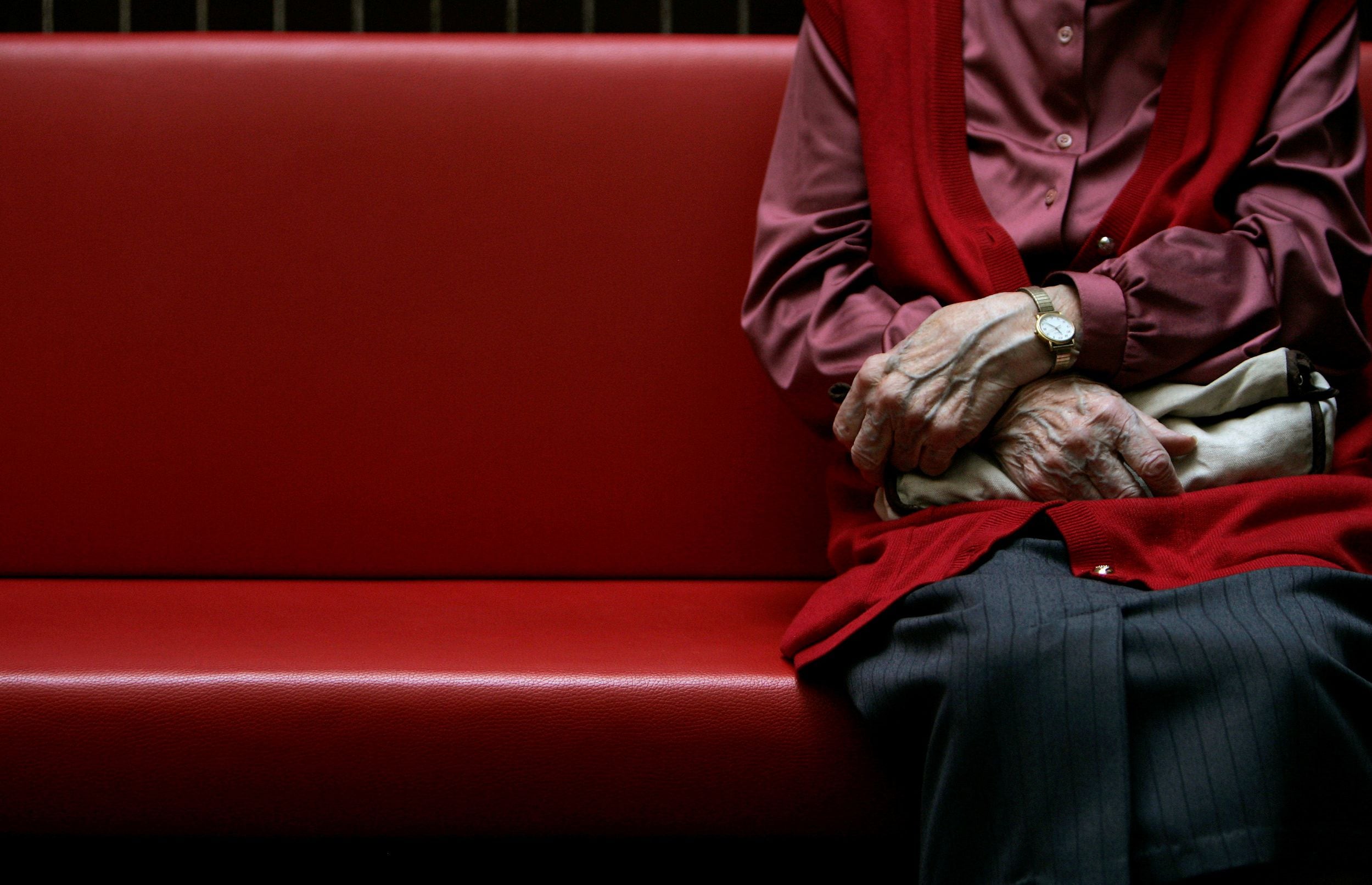 FILE PHOTO: A pensioner sits in a residential home for the elderly in Emmenbruecke