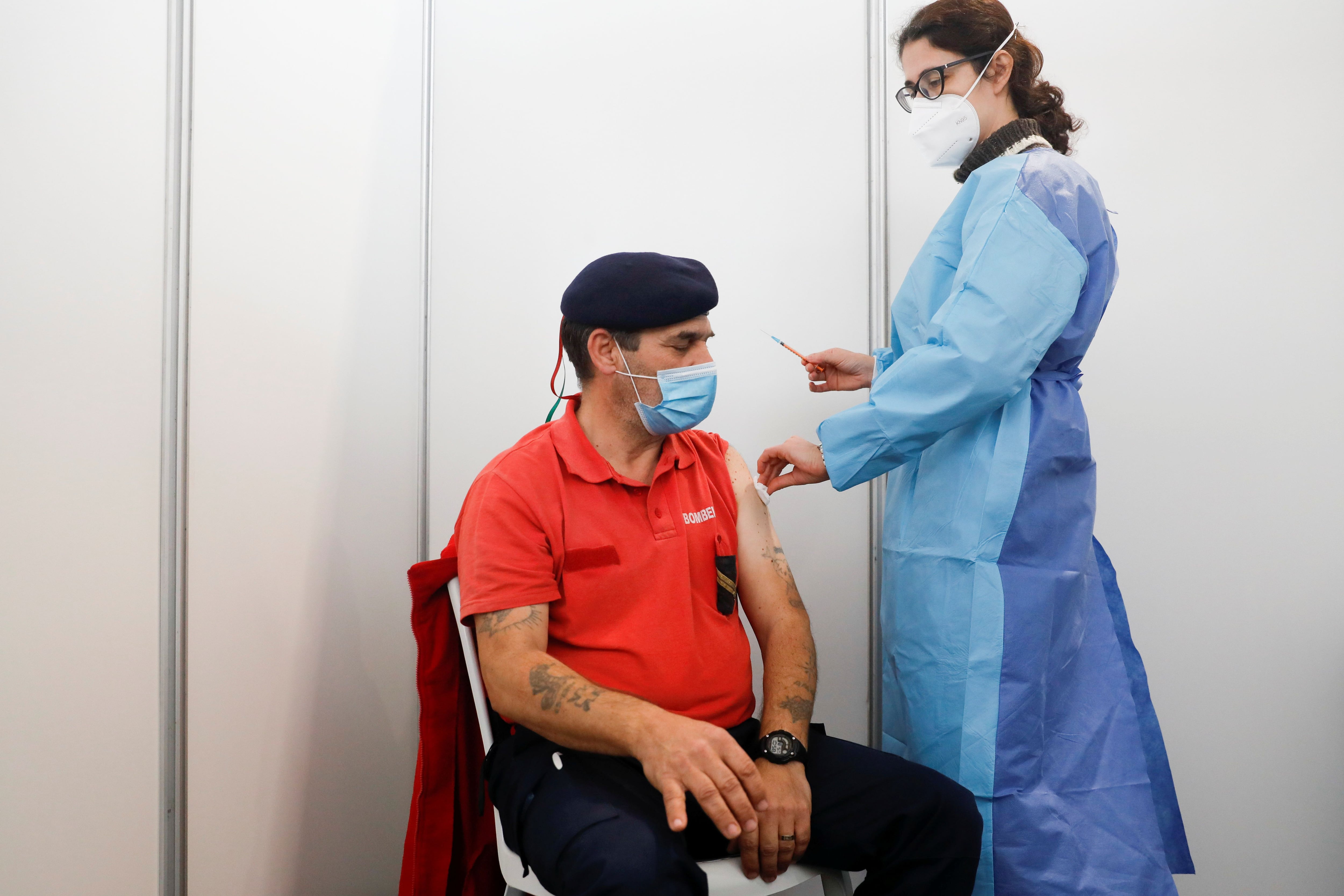 A firefighter receives the Pfizer-BioNTech coronavirus disease (COVID-19) vaccine in a vaccination centre in Seixal, amid the coronavirus disease (COVID-19) pandemic, in Seixal