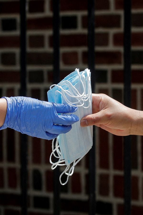 FILE PHOTO: A woman receives protective face masks in New York City