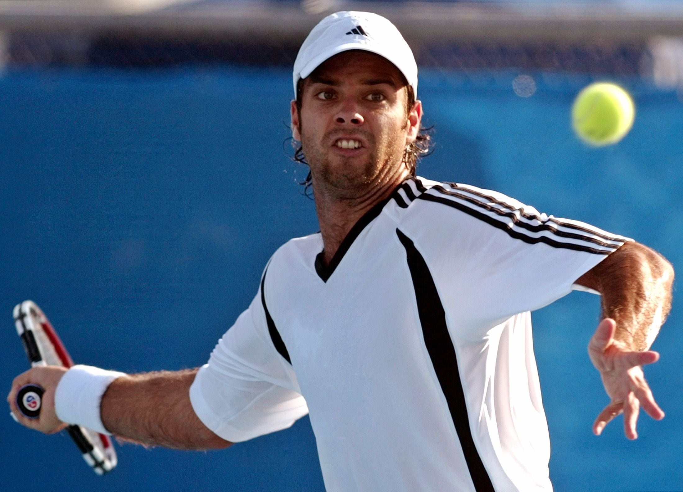 Chiles Gonzalez returns the ball to Frances Grosjean during their match at the Athens 2004 Olympic Games.