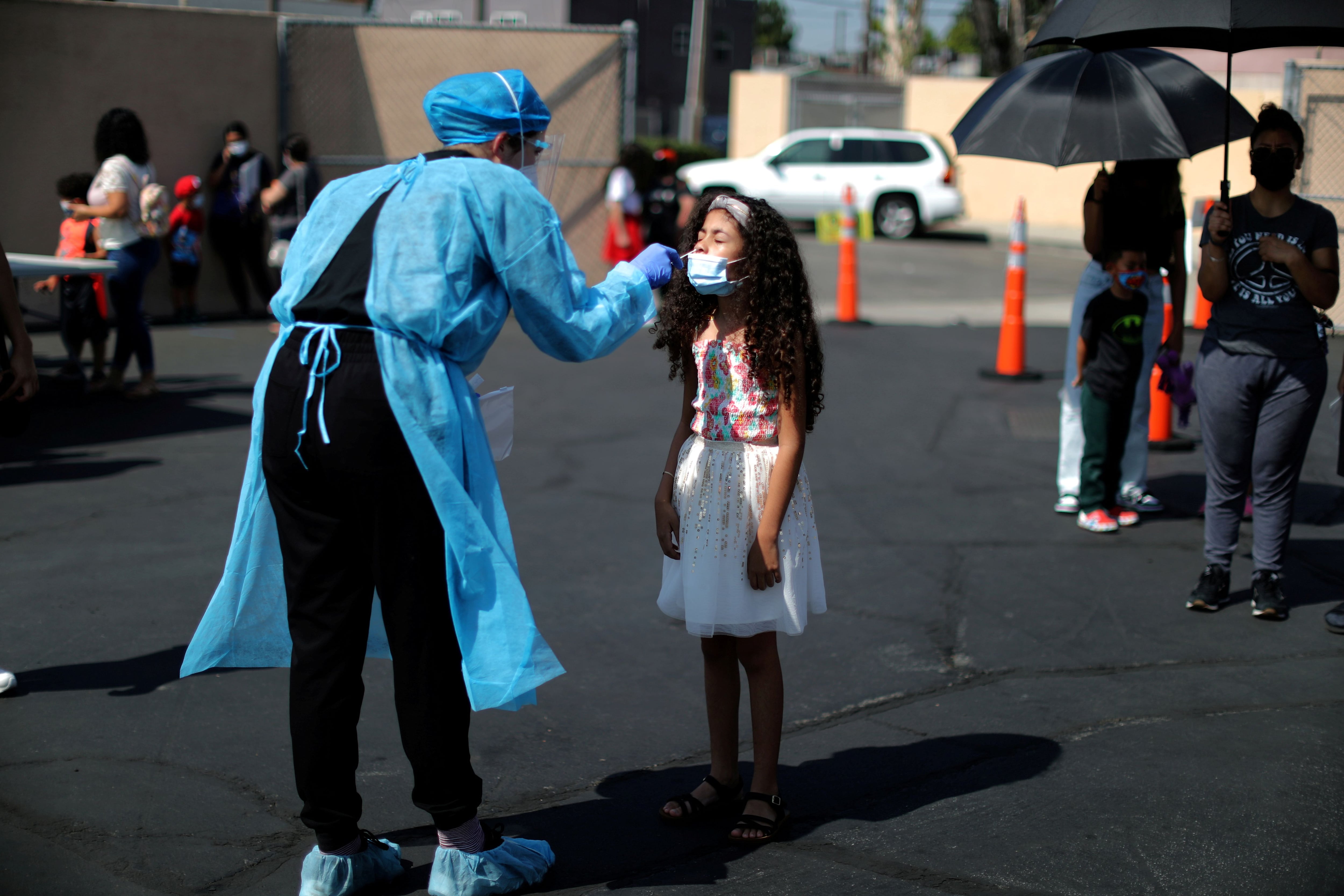 FILE PHOTO: Alisson Argueta, 8, is given a COVID-19 test at a back-to-school clinic in Los Angeles