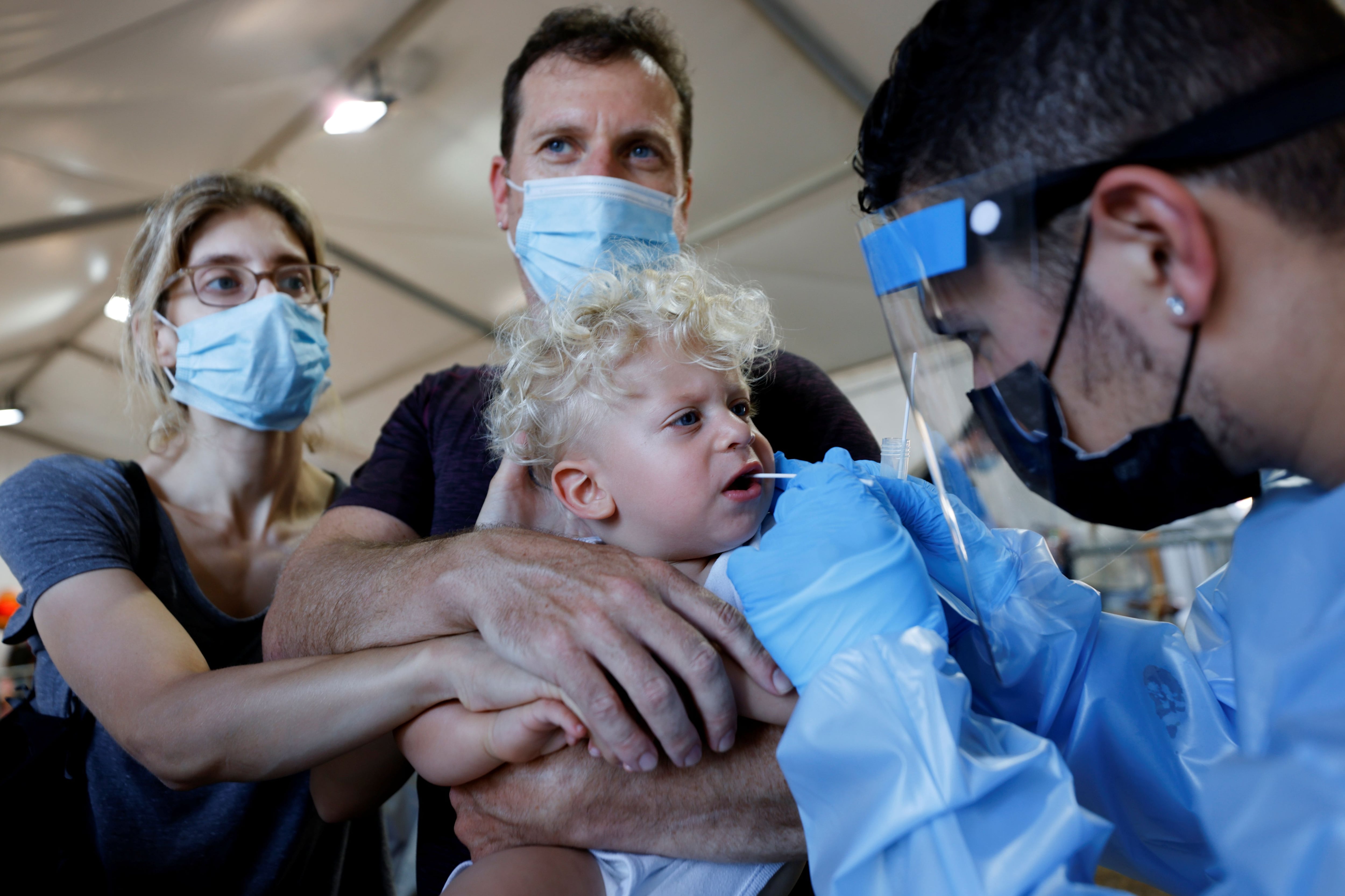 People wait to be tested at a temporary coronavirus disease (COVID-19) testing centre in Tel Aviv