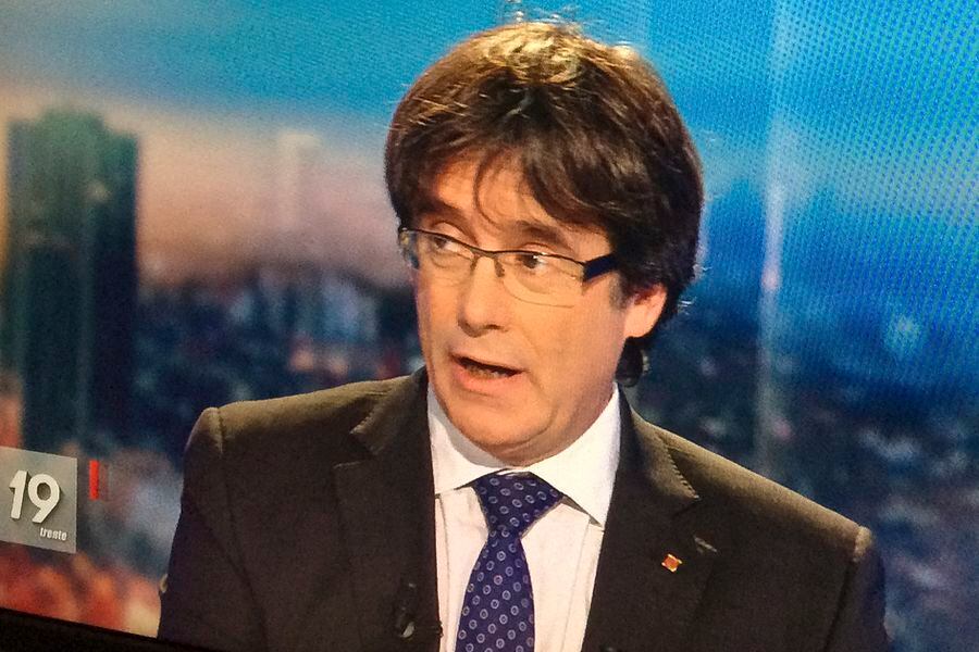 Ousted Catalan President Carles Puigdemont appears on a monitor during a live TV interview in Brussels