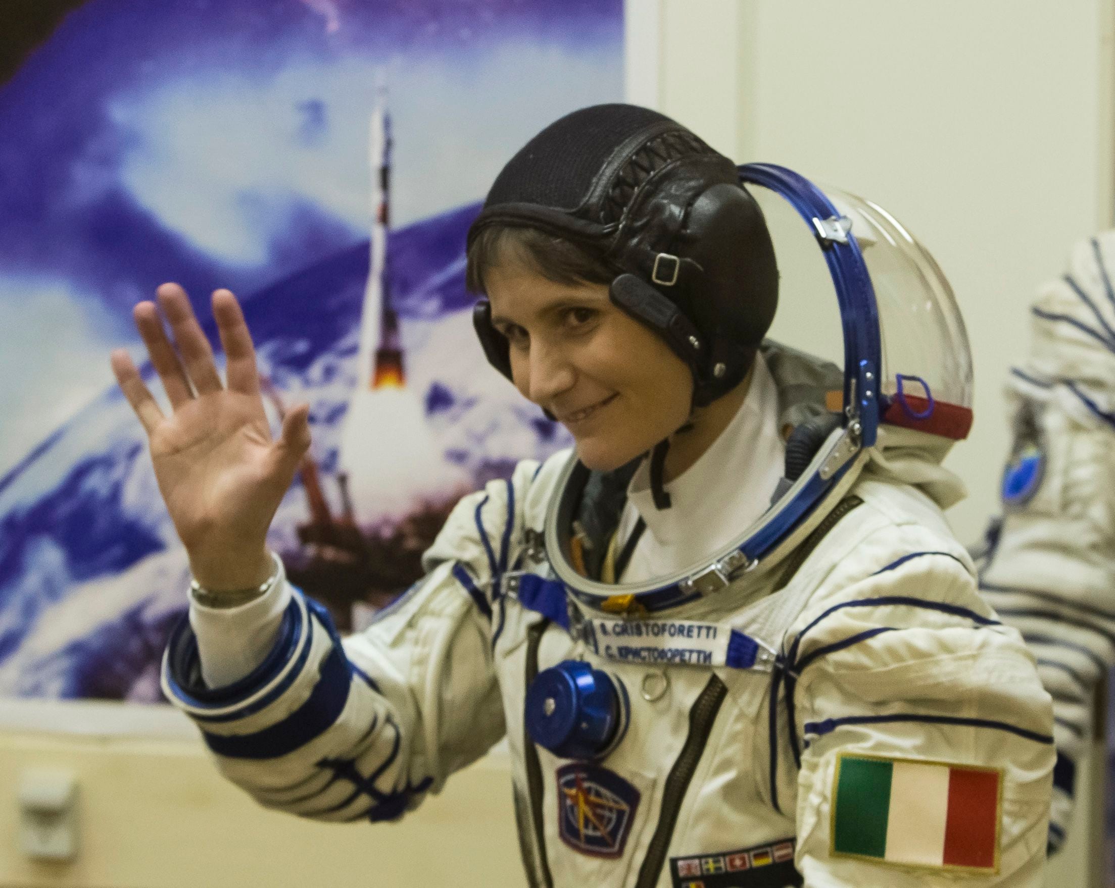 Samantha Cristoforetti of Italy waves after donning her space suit at the Baikonur cosmodrome