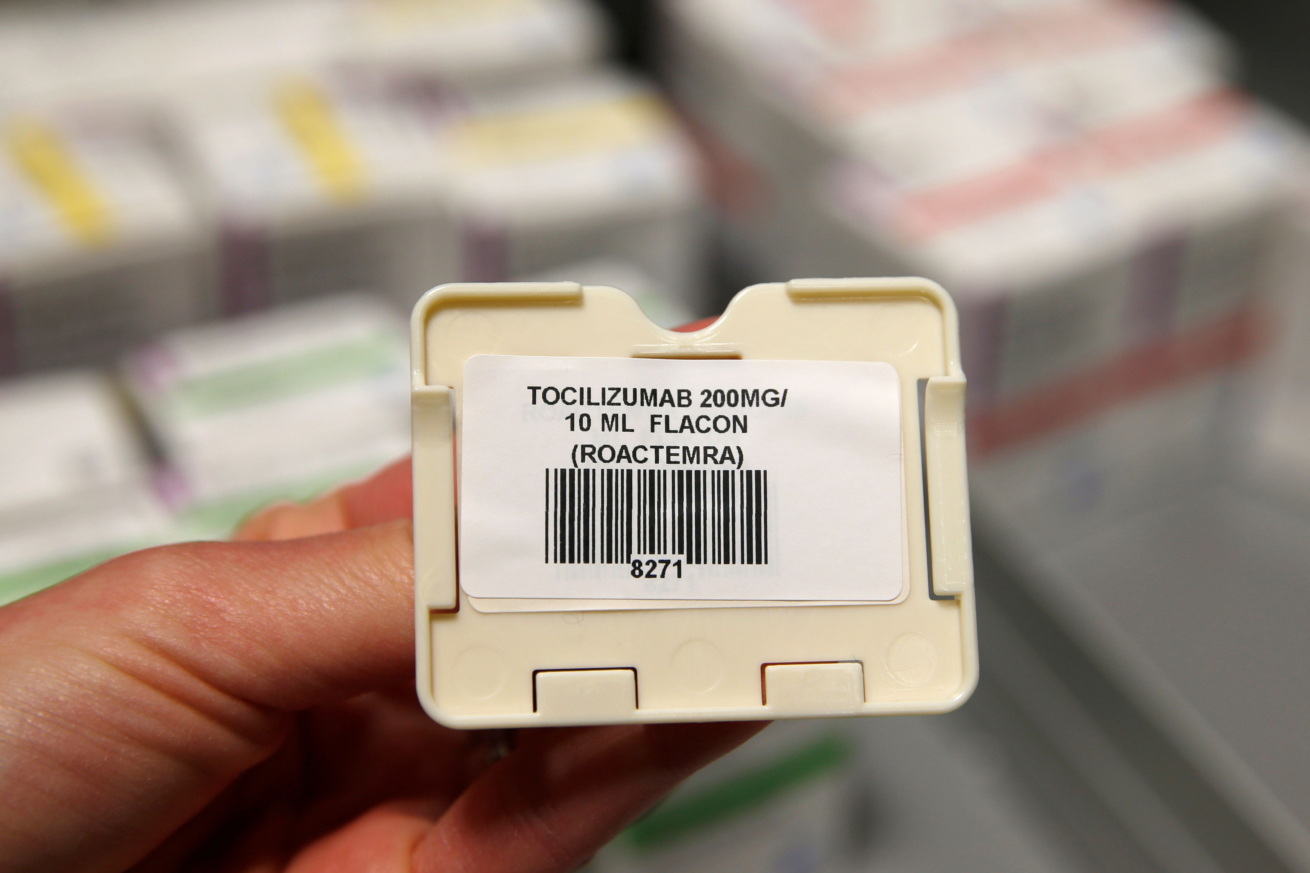 A pharmacist displays a sticker with the name of tocilizumab molecule at the pharmacy of Cambrai hospital