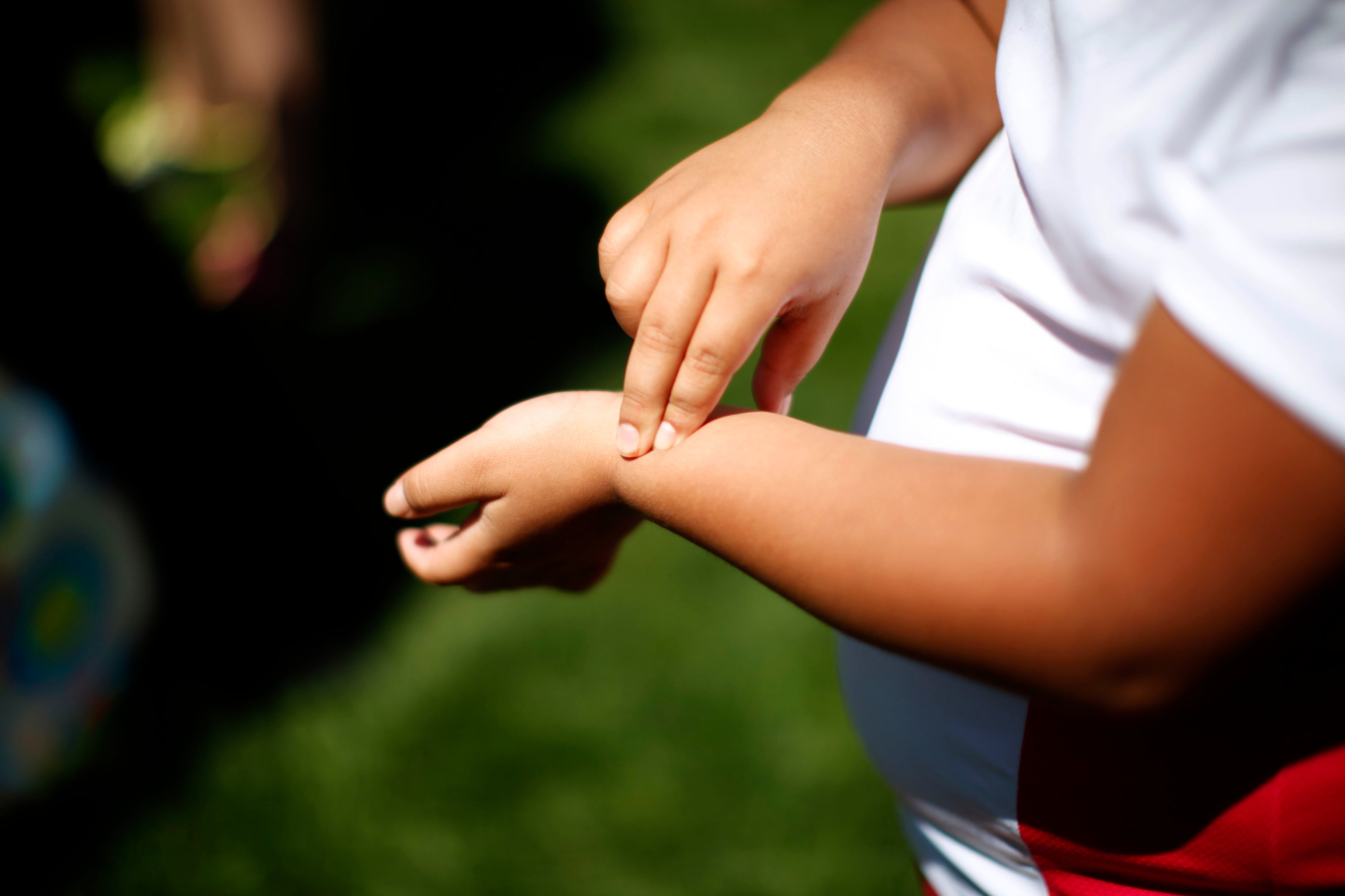 Fernanda Garcia-Villanueva, 8, takes her pulse at a group exercise session in the 10-week Shapedown Program at The Children's Hospital in Aurora