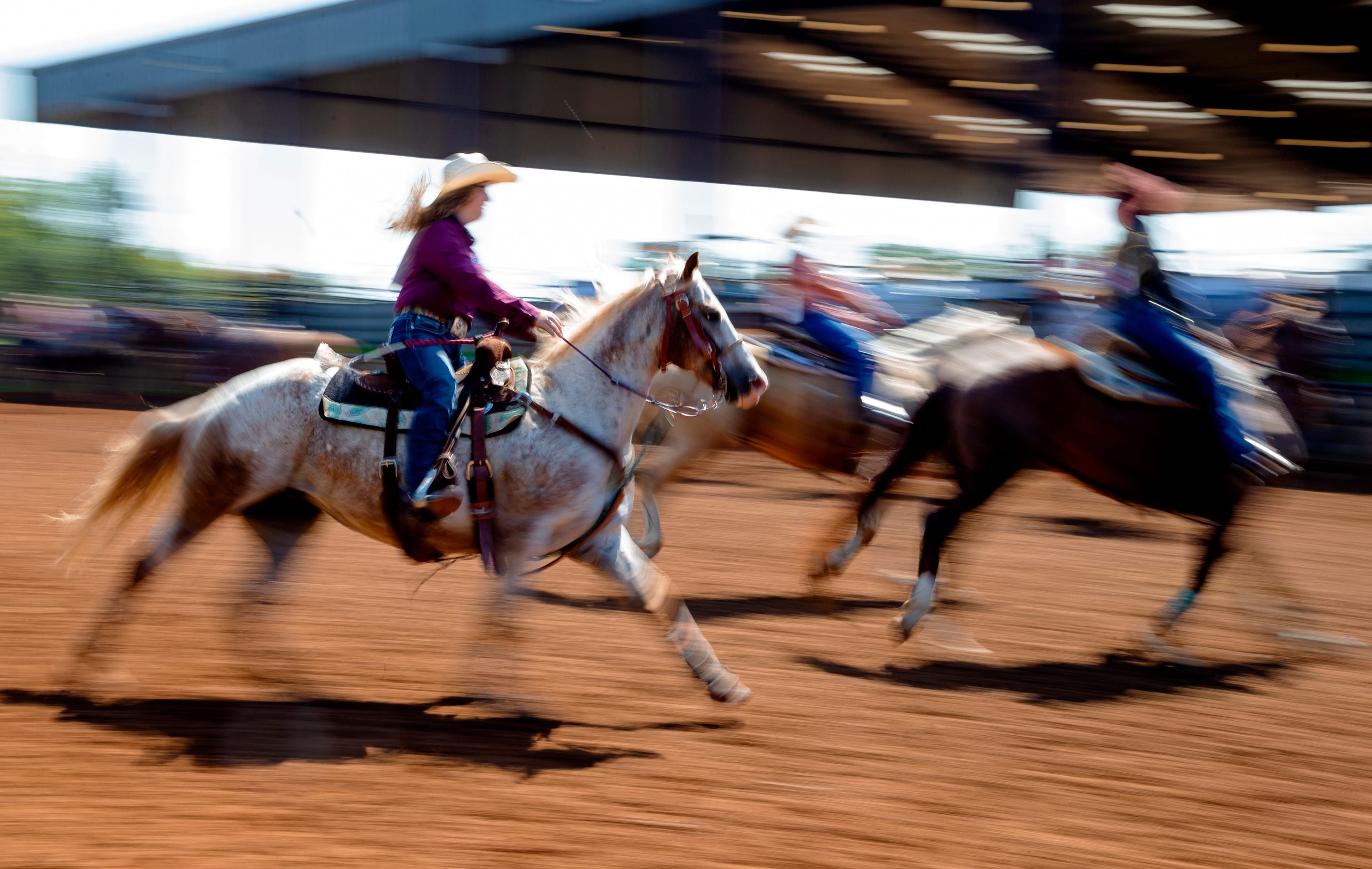 Competitors warm up their horses outside the arena before competing in the National Little Britches Finals Rodeo at the Lazy E