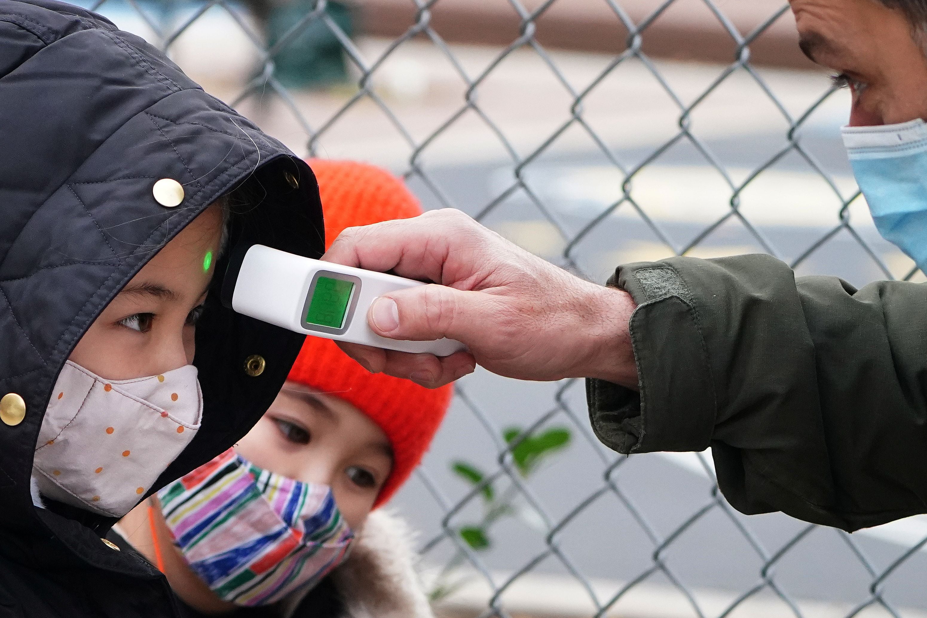 A child has his temperature checked before attending class at PS 361 on the first day of a return to class during the coronavirus disease (COVID-19) pandemic in the Manhattan borough of New York City