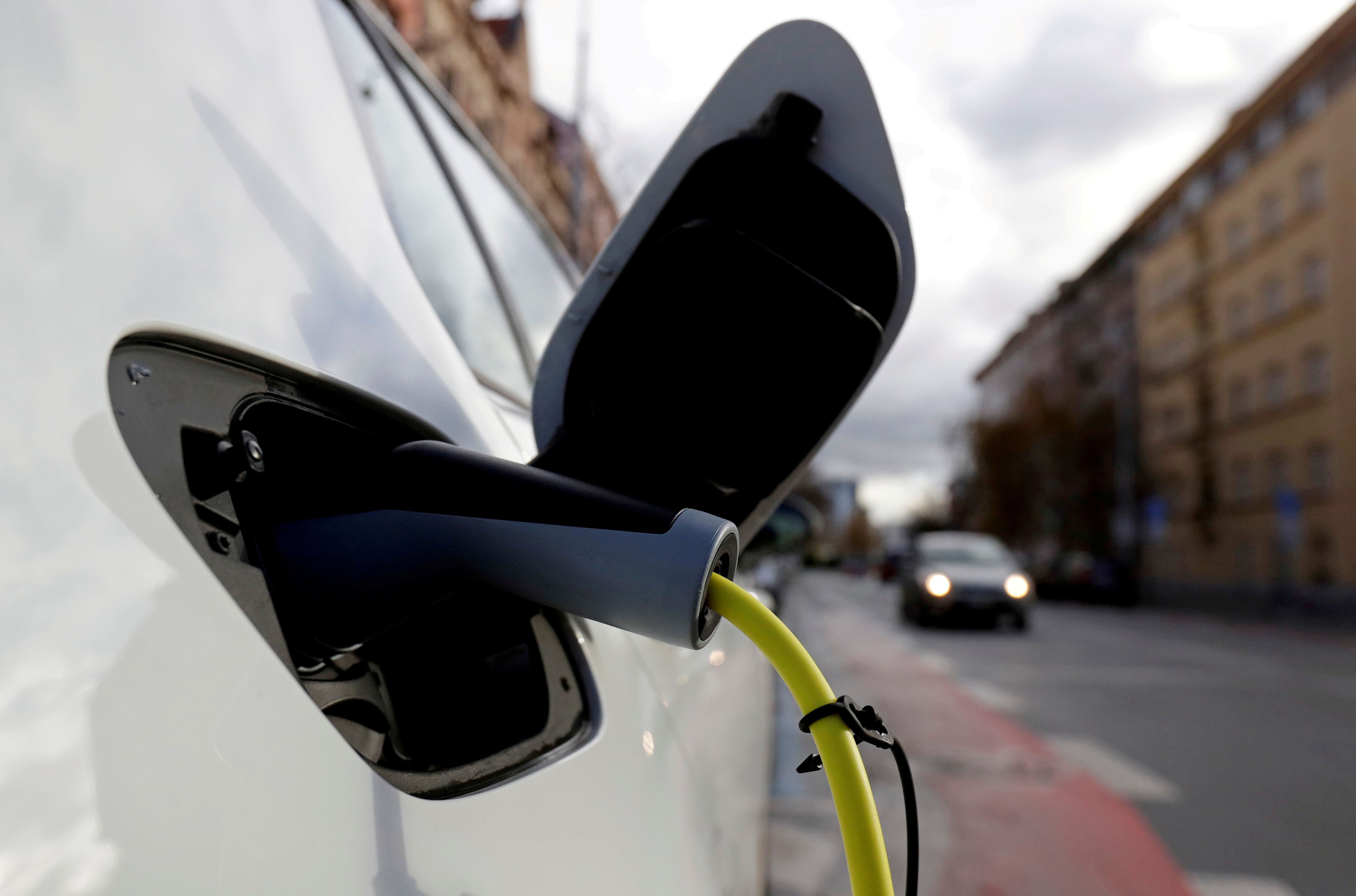 FILE PHOTO: An electric car is charged by a mobile charging station on a street in Prague