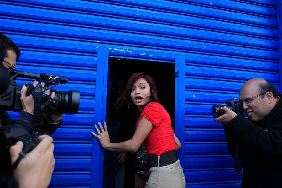 Venegas, girlfriend of U.S. software pioneer McAfee, enters a migrant shelter where he is being detained, in Guatemala City