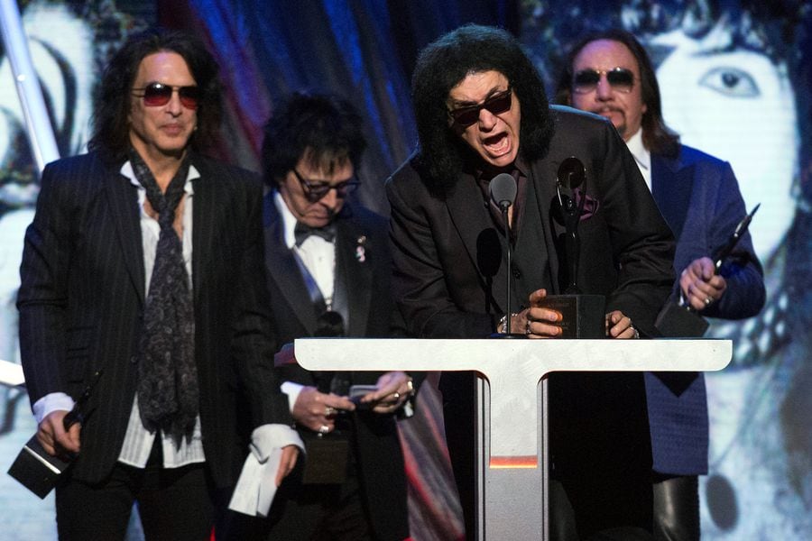 FILE PHOTO: Simmons of the rock band Kiss speaks next to fellow band members Stanley, Criss and Frehley after Kiss was inducted at 29th annual Rock and Roll Hall of Fame Induction Ceremony in Brooklyn, New York