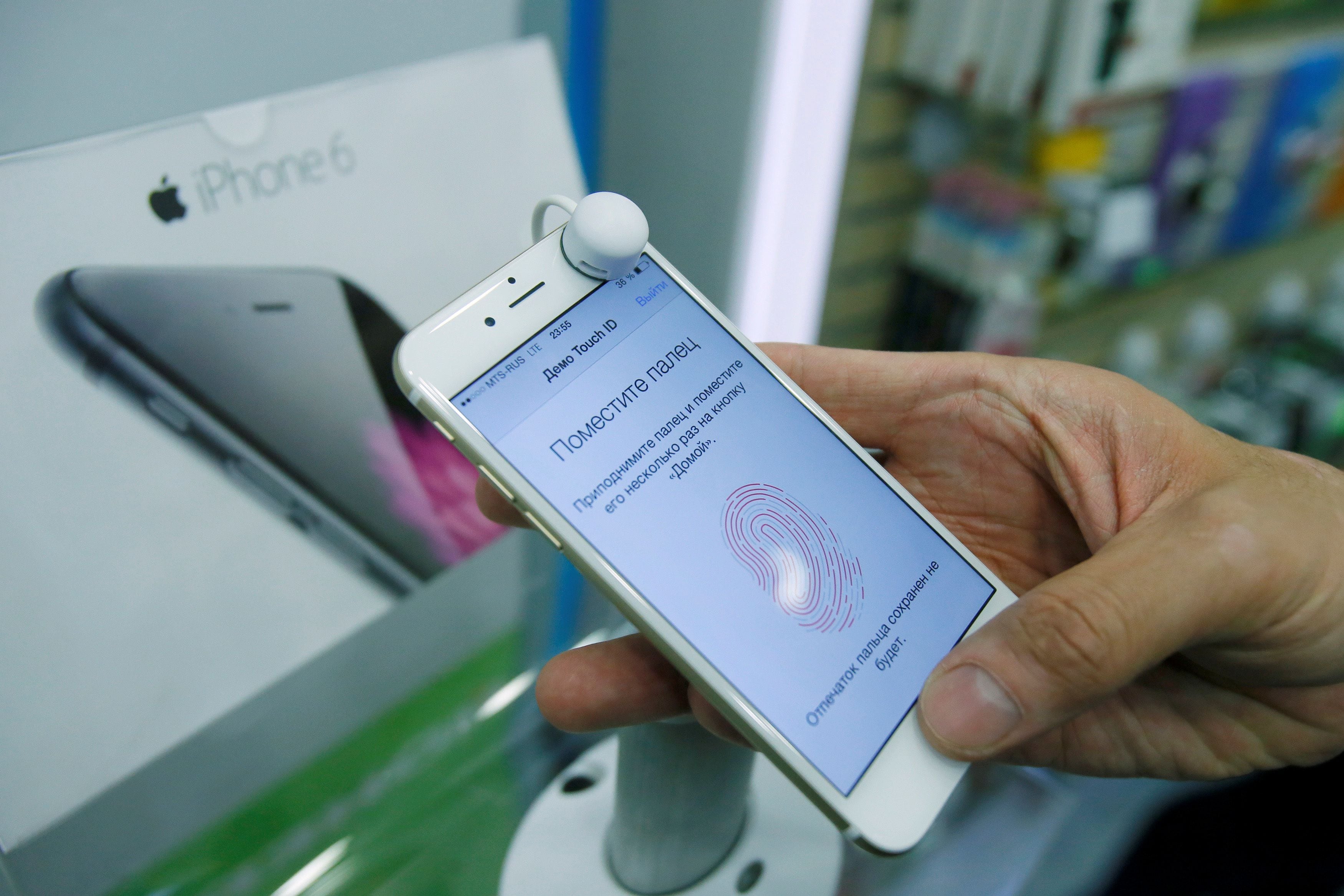 FILE PHOTO: Man holds iPhone 6 in mobile phone shop in Moscow