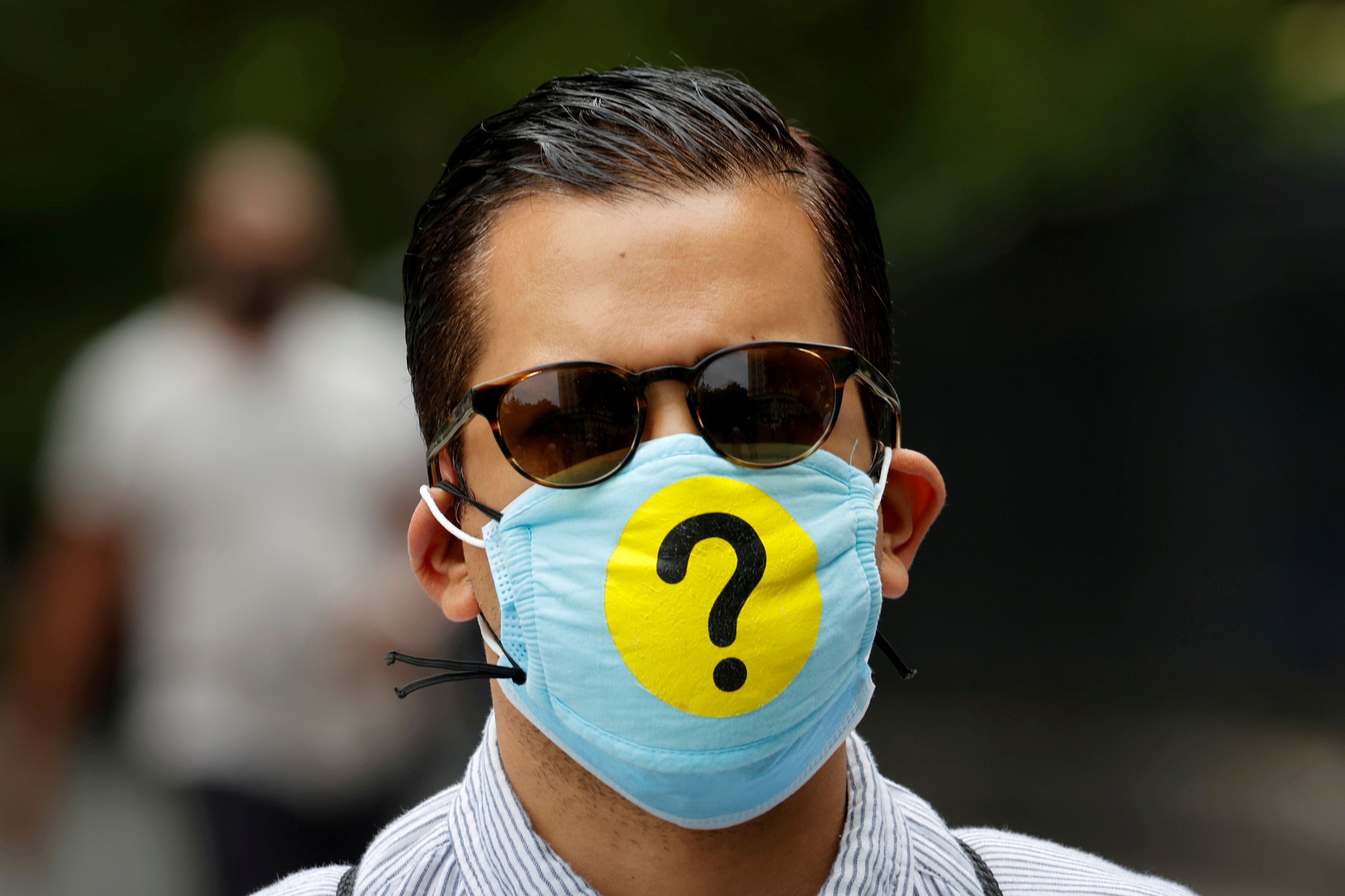 Man wears a protective face mask decorated with a question mark during outbreak of the coronavirus disease (COVID-19) in New York