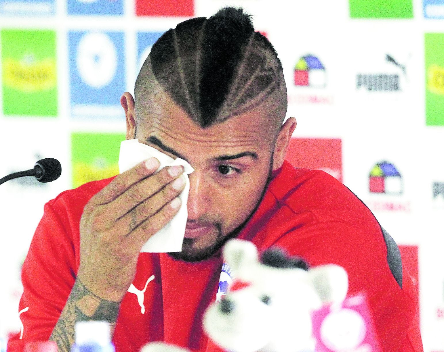 Chile's national football player Arturo Vidal sobs as he delivers a p